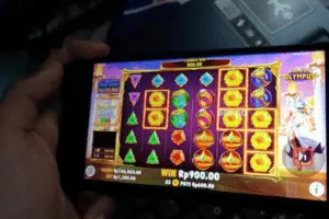 Slots Gossip 143 online slots on mobile device being played by a man