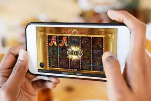 Slots Gossip 141 man playing online slots on mobile